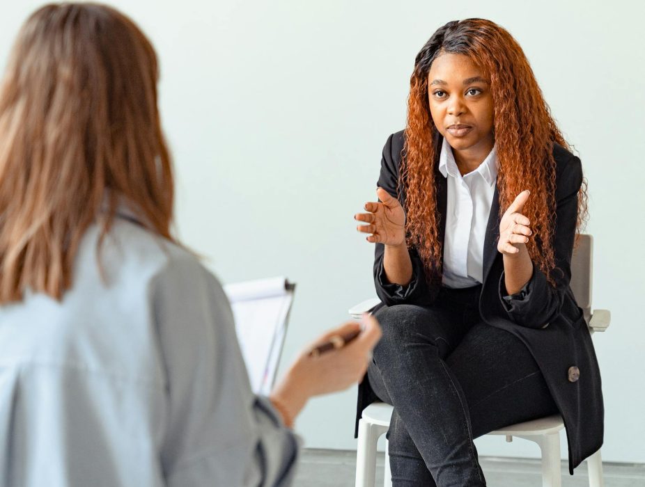 a-mental-health-professional-talking-with-a-patient-in-a-therapy-session-indoors.-7579190-scaled